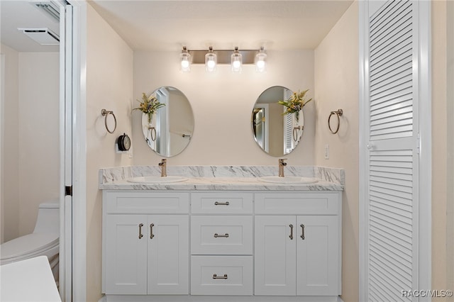 bathroom with vanity and toilet