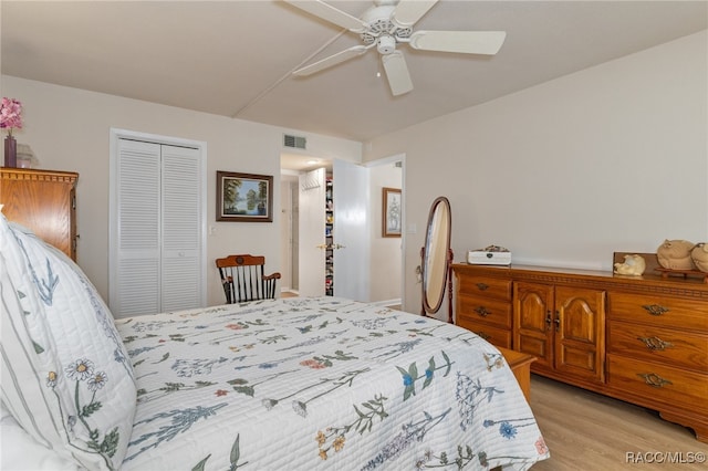 bedroom featuring ceiling fan, light hardwood / wood-style floors, and a closet