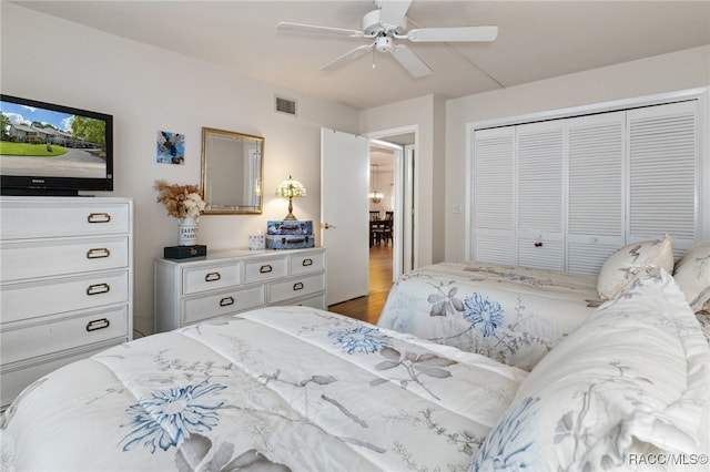 bedroom featuring ceiling fan, a closet, and wood-type flooring