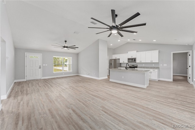 unfurnished living room featuring light wood-type flooring, ceiling fan, lofted ceiling, and sink