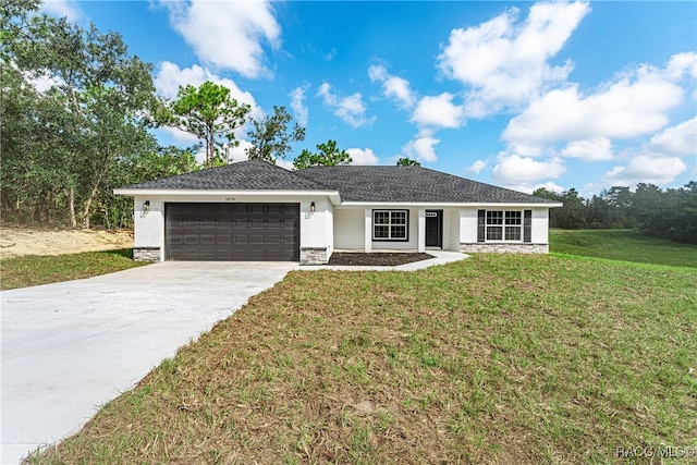 ranch-style house with a garage and a front lawn