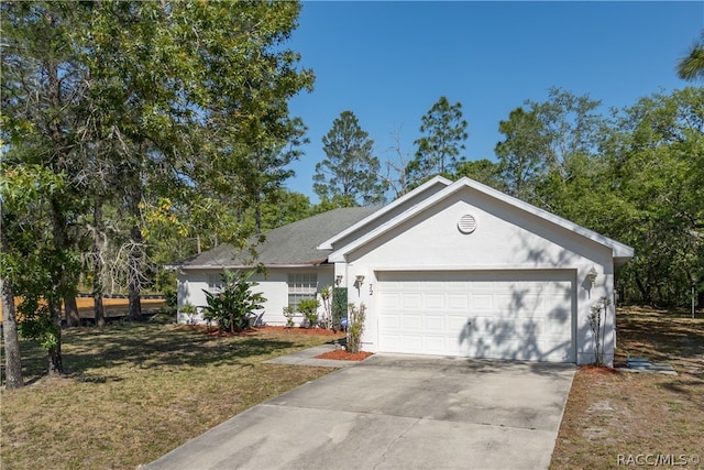 ranch-style house featuring a garage and a front lawn