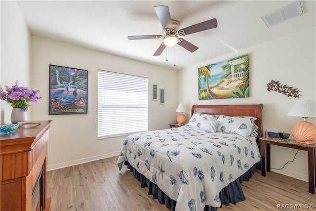 bedroom with ceiling fan and light hardwood / wood-style floors