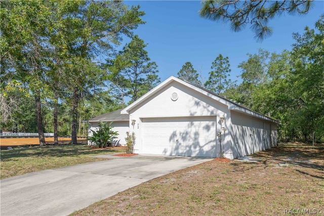 exterior space featuring a garage and a yard