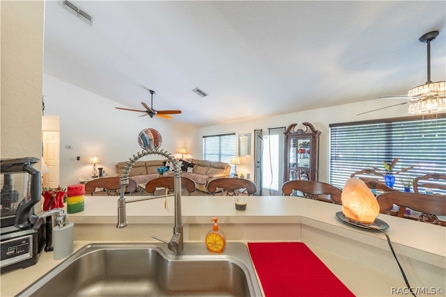 kitchen with ceiling fan, lofted ceiling, and sink