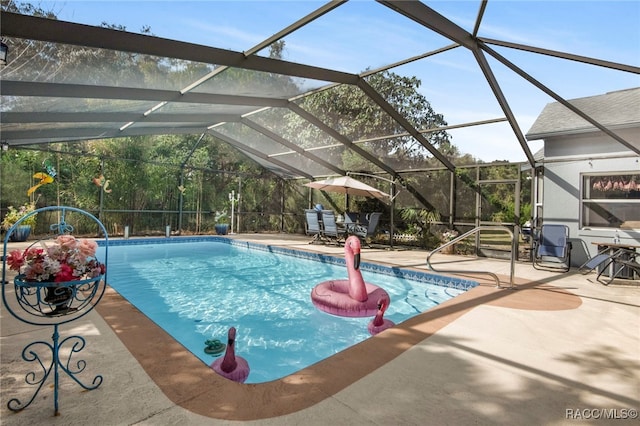 view of pool with a lanai and a patio area