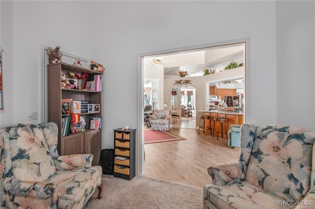 sitting room featuring ceiling fan and light wood-type flooring