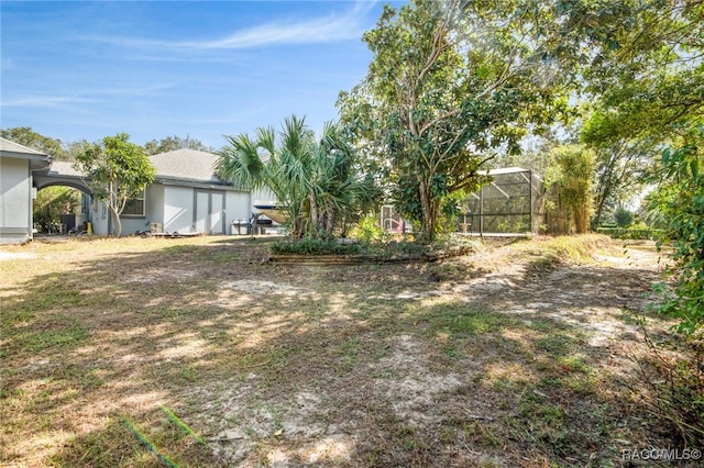 view of yard with a lanai