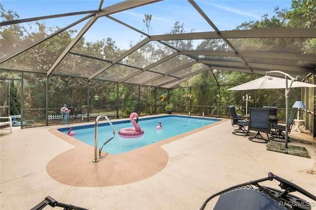 view of swimming pool featuring glass enclosure and a patio area