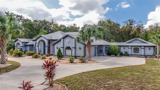 single story home featuring a front yard and a garage