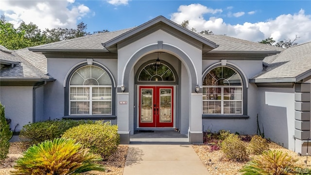 view of exterior entry featuring french doors