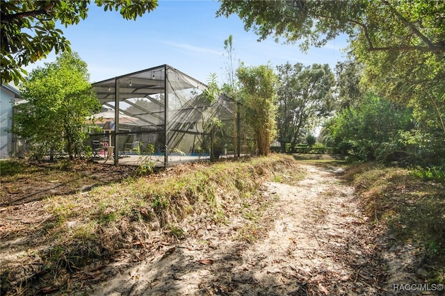 view of yard with glass enclosure