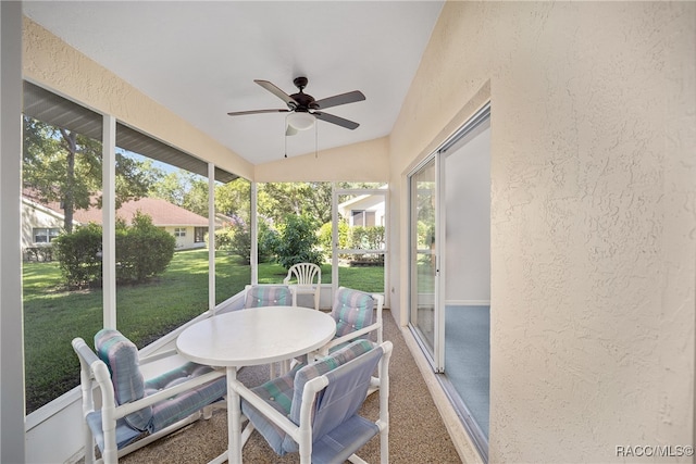 sunroom / solarium featuring ceiling fan and vaulted ceiling