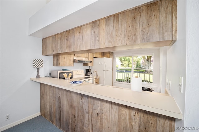 kitchen featuring white appliances and carpet floors