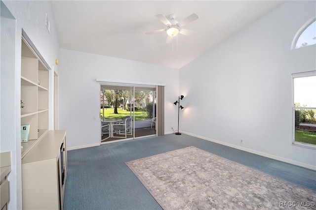 interior space featuring a healthy amount of sunlight, carpet floors, and vaulted ceiling