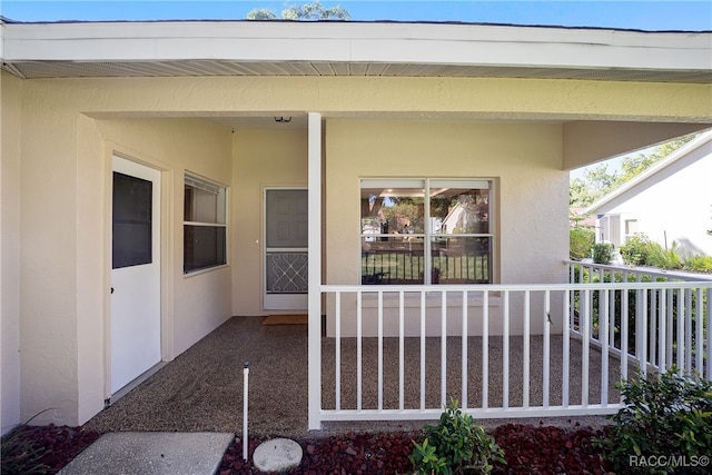 entrance to property featuring covered porch