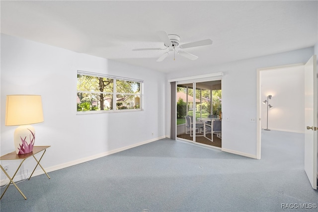 empty room with carpet flooring and ceiling fan