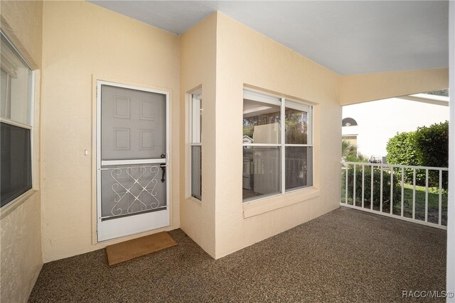 entrance to property featuring a balcony