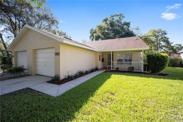 single story home featuring covered porch, a front yard, and a garage