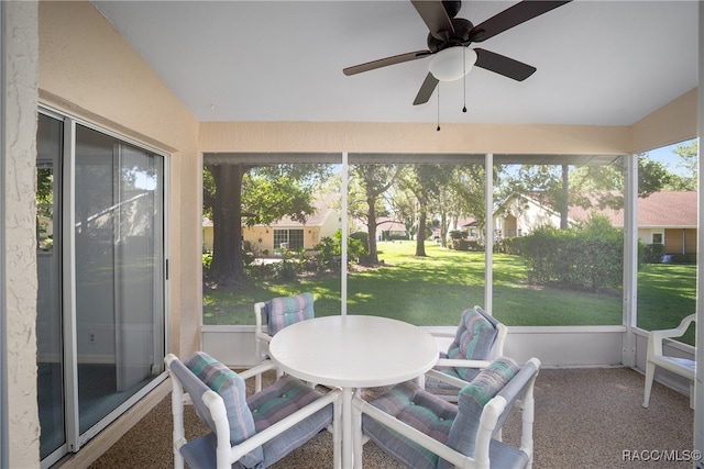 sunroom / solarium with ceiling fan and a healthy amount of sunlight