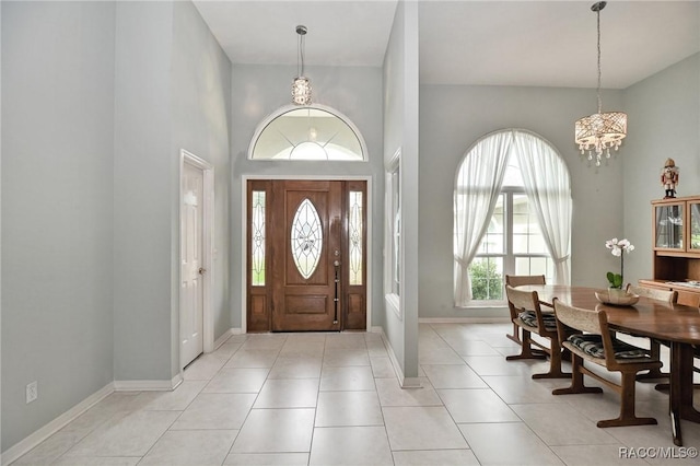 705 E Dakota Ct, Hernando, FL 34442 - foyer featuring a chandelier, a towering ceiling, baseboards, and light tile patterned floors