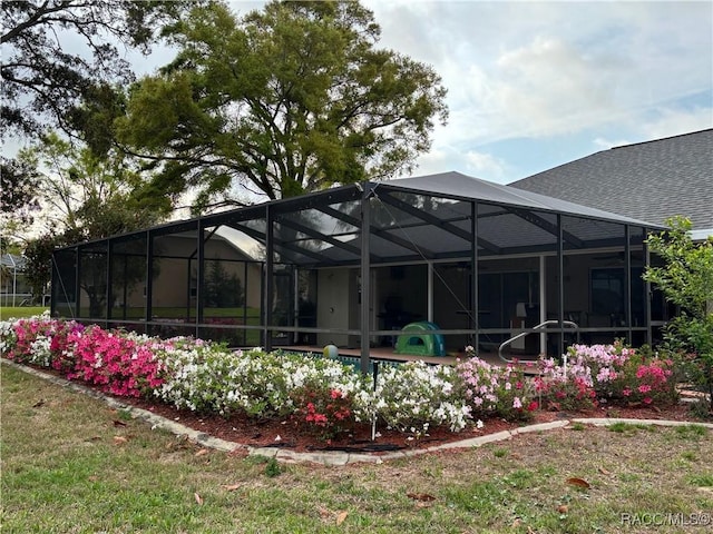 705 E Dakota Ct, Hernando, FL 34442 - back of property with roof with shingles, an outdoor pool, and a lanai