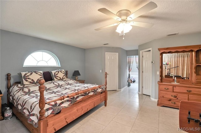 705 E Dakota Ct, Hernando, FL 34442 - bedroom with light tile patterned floors, a textured ceiling, ceiling fan, and baseboards
