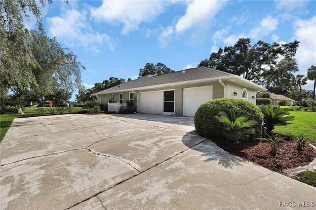 705 E Dakota Ct, Hernando, FL 34442 - view of front of home featuring an attached garage, concrete driveway, and stucco siding
