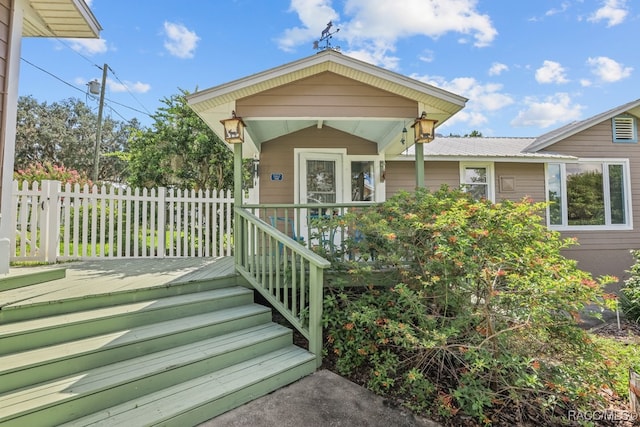 property entrance featuring a wooden deck