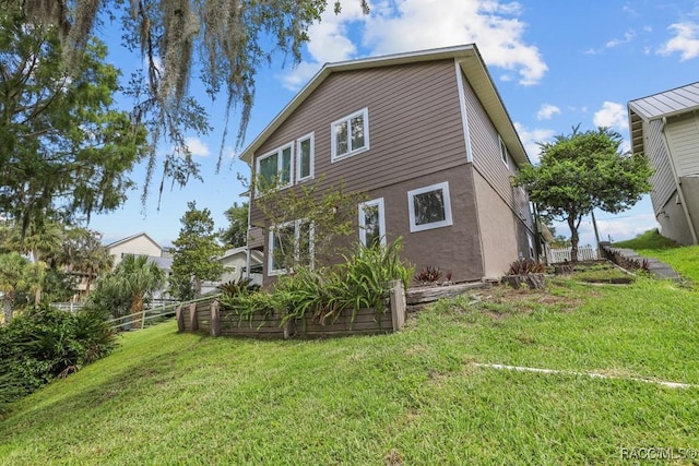 back of house with a lawn