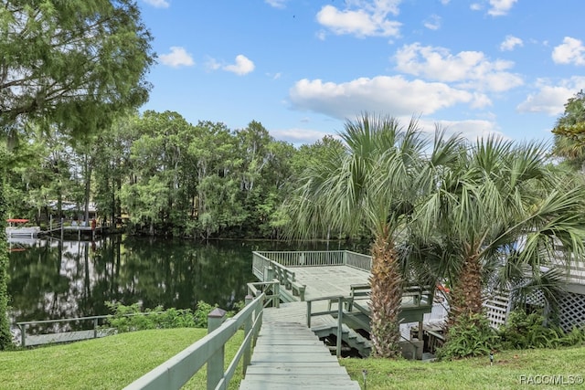 dock area featuring a yard and a water view