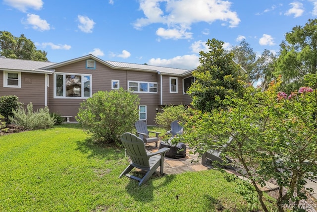 back of property featuring a yard and a patio