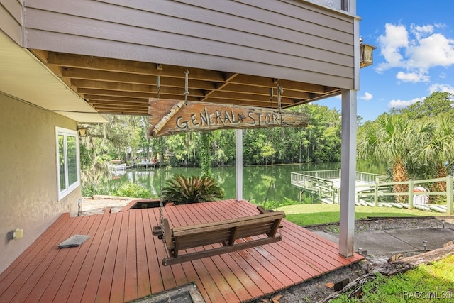 deck with a boat dock and a water view