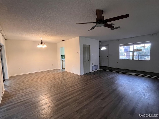 unfurnished living room featuring visible vents, baseboards, dark wood finished floors, a textured ceiling, and ceiling fan with notable chandelier