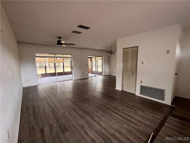 unfurnished living room featuring dark wood-style flooring, visible vents, and a ceiling fan