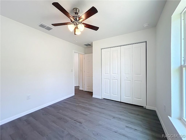 22777 SW Beach Blvd, Dunnellon, FL 34431 - unfurnished bedroom featuring dark wood-type flooring, baseboards, a closet, and a ceiling fan