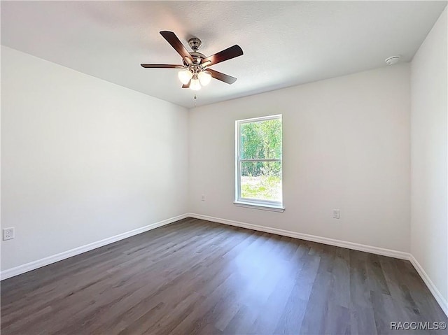 22777 SW Beach Blvd, Dunnellon, FL 34431 - unfurnished room featuring dark wood finished floors, baseboards, a ceiling fan, and a smoke detector