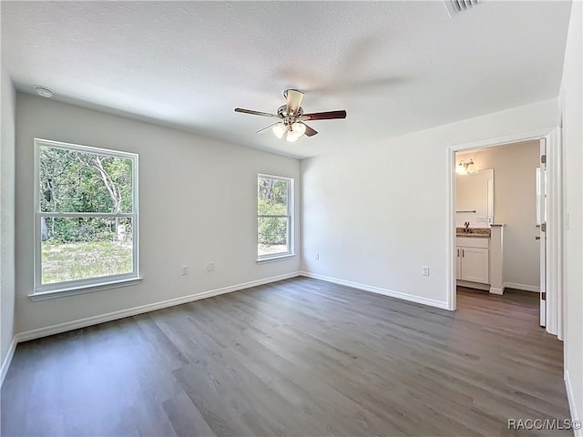 22777 SW Beach Blvd, Dunnellon, FL 34431 - spare room featuring dark wood finished floors, a ceiling fan, baseboards, and a sink
