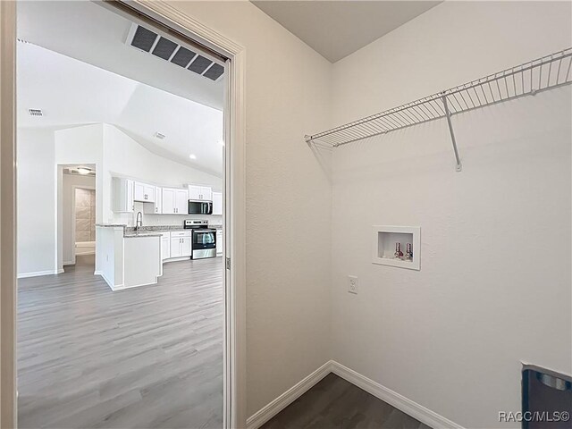 22777 SW Beach Blvd, Dunnellon, FL 34431 - laundry room featuring wood finished floors, washer hookup, and baseboards