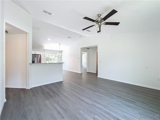 22777 SW Beach Blvd, Dunnellon, FL 34431 - unfurnished living room with vaulted ceiling, a ceiling fan, baseboards, and dark wood-type flooring