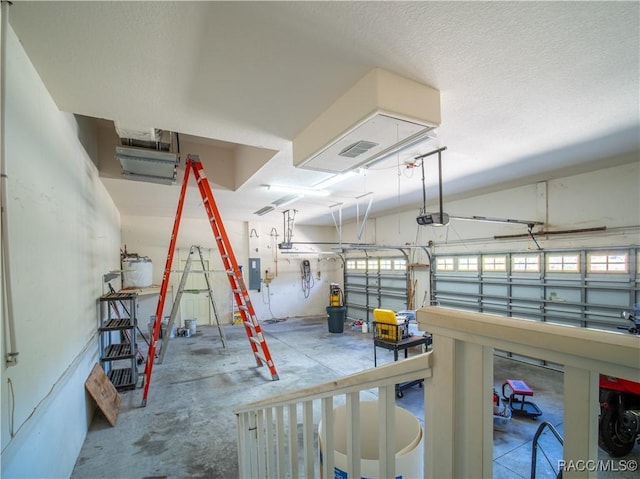 garage featuring a garage door opener and electric panel