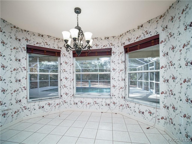 unfurnished dining area featuring a notable chandelier and tile patterned floors