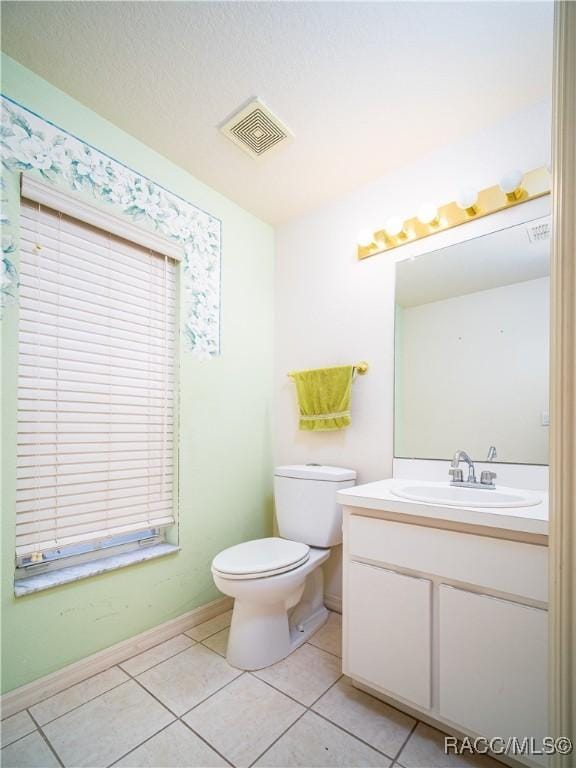 bathroom featuring tile patterned floors, toilet, and vanity