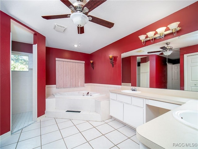 bathroom featuring ceiling fan, vanity, tiled bath, and tile patterned flooring