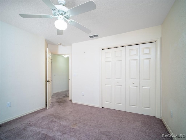 unfurnished bedroom with light colored carpet, a textured ceiling, ceiling fan, and a closet