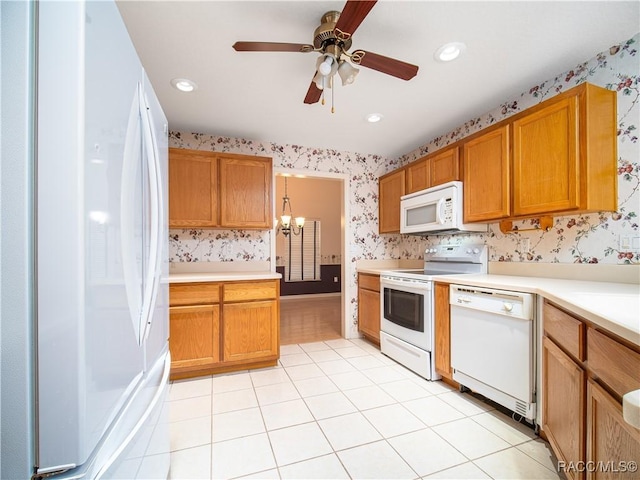 kitchen featuring ceiling fan with notable chandelier, light tile patterned floors, and white appliances