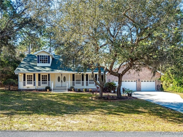 view of front of house featuring a garage, covered porch, and a front lawn