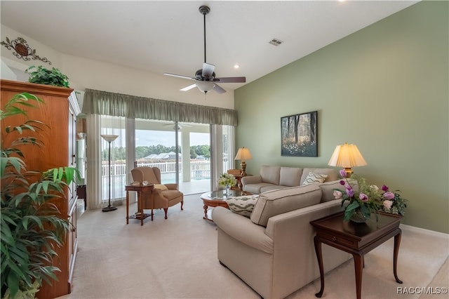 carpeted living room with ceiling fan