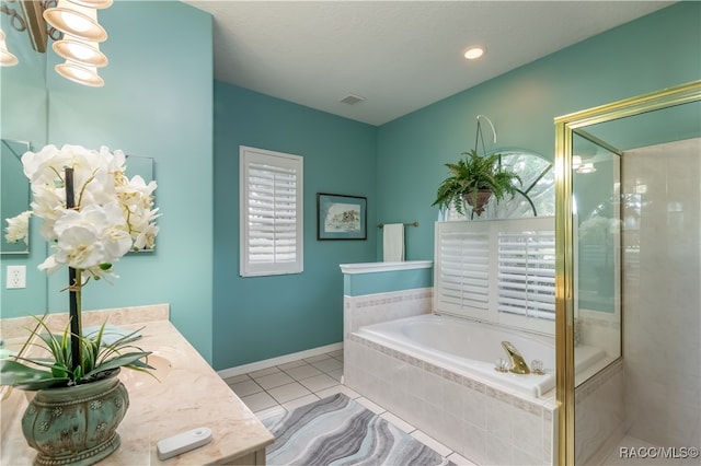 bathroom with tile patterned flooring, vanity, and plus walk in shower