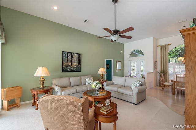 living room featuring ceiling fan, light colored carpet, and french doors